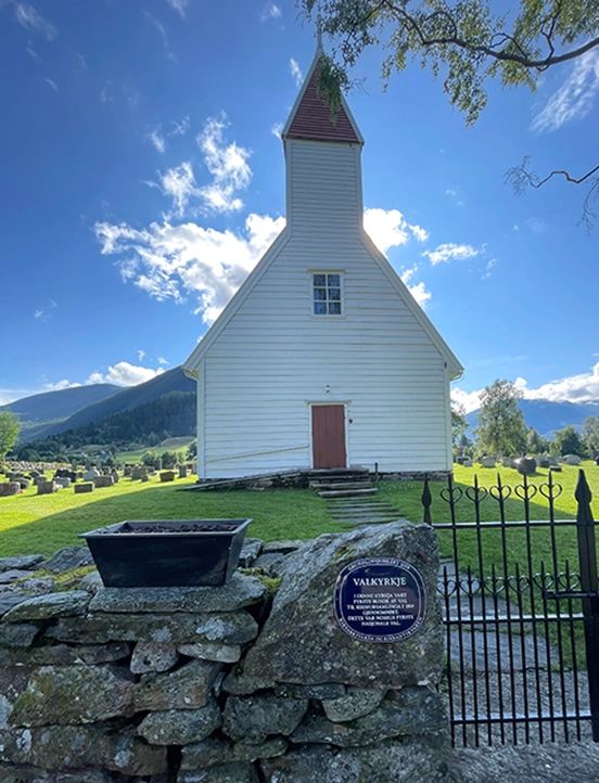 Historic white church in a mountain valley — a symbol of enduring faith